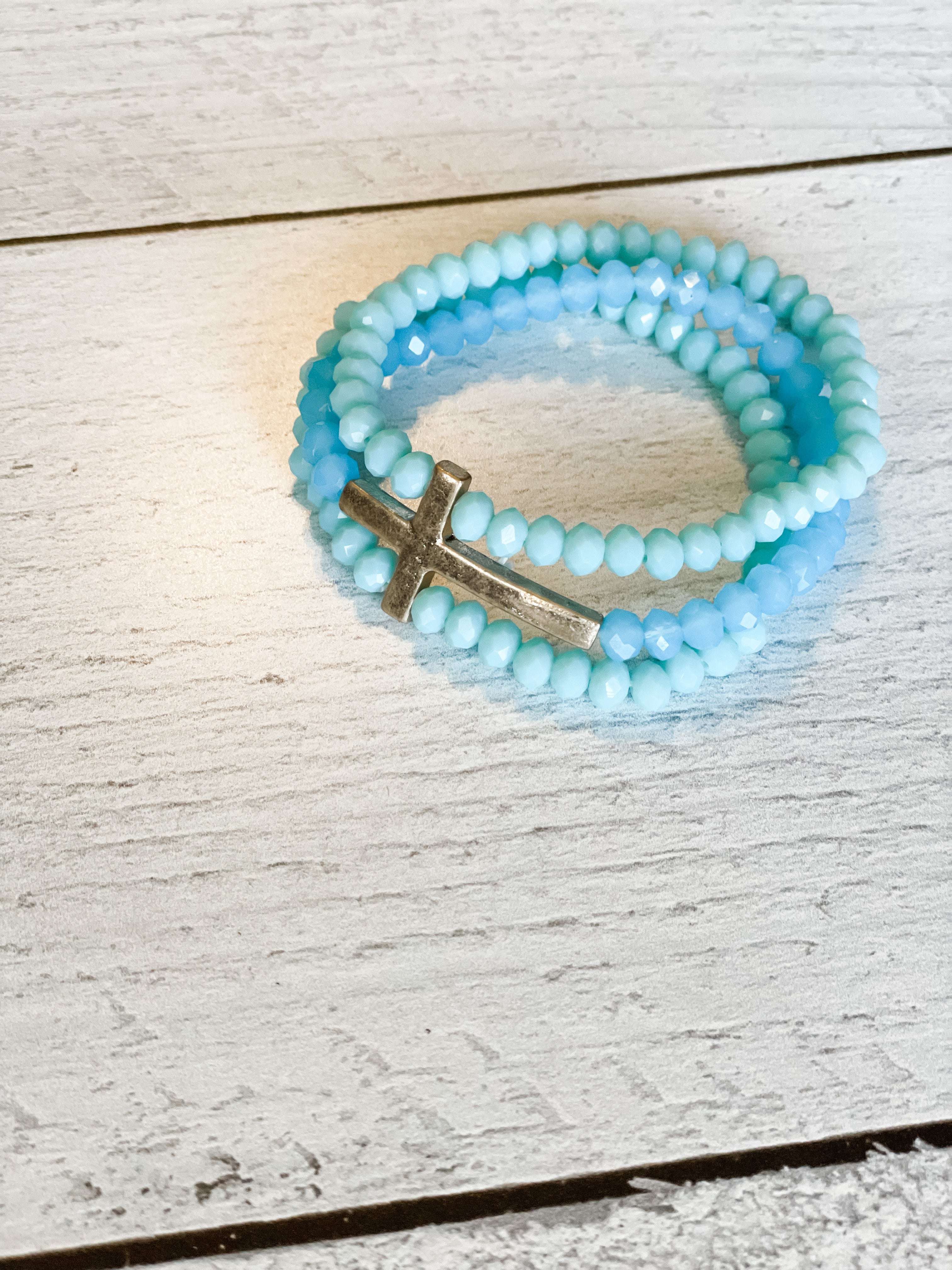 beautiful aqua glass bead 3-strand bracelet with gold cross accent piece