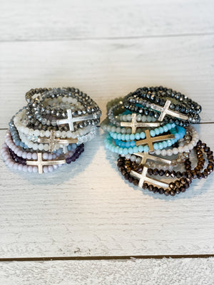 collection of all available colors of the beaded 3-strand bracelets with cross accent