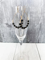 gold and black teardrop earrings with glass beads